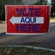 A bilingual sign stands outside a polling center at public library ahead of local elections April 28, 2013, in Austin, Texas.
John Moore/Getty Images
